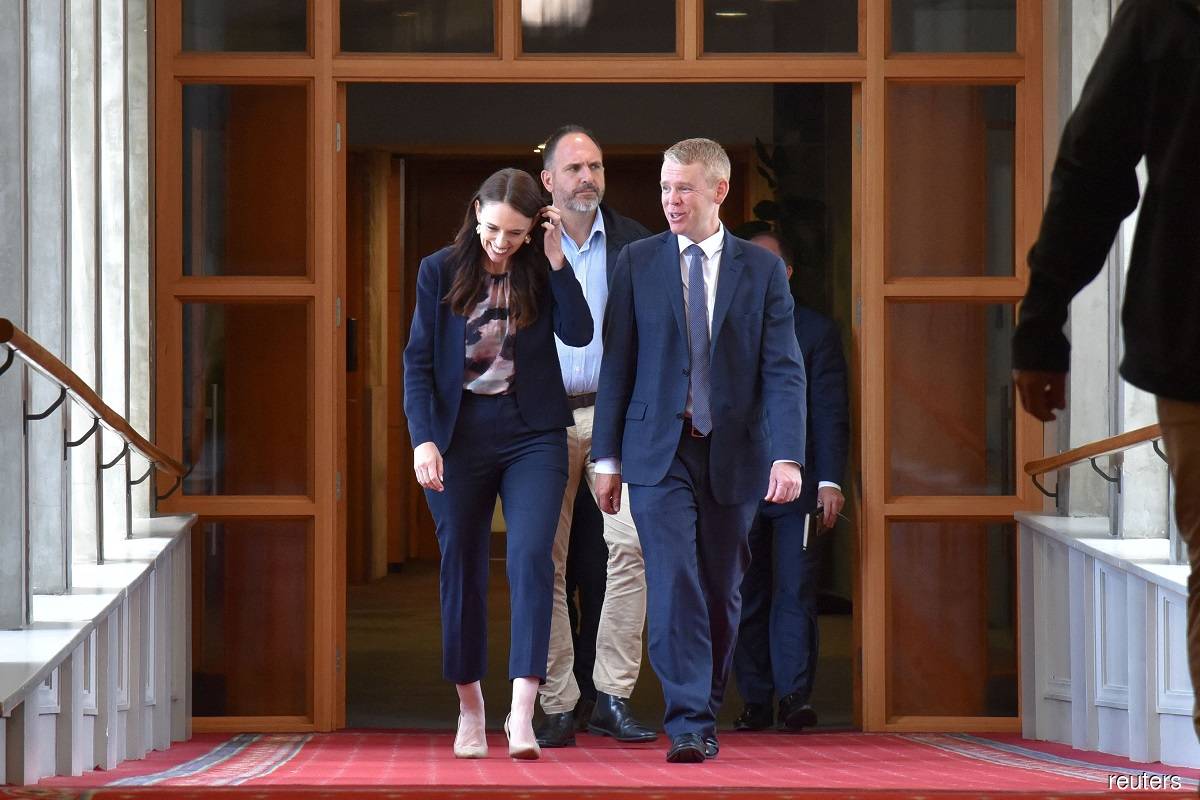 Former New Zealand prime minister Jacinda Ardern walking with Chris Hipkins at the Parliament House in Wellington, New Zealand on Sunday (Jan 22), ahead of a vote to confirm Hipkins as Labour's leader, replacing Ardern. (AAP image via Reuters)